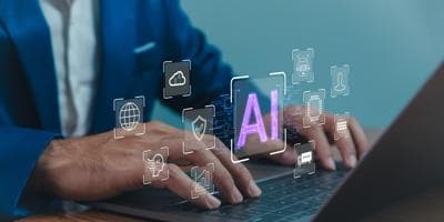 Close-up of a businessman using AI on a laptop