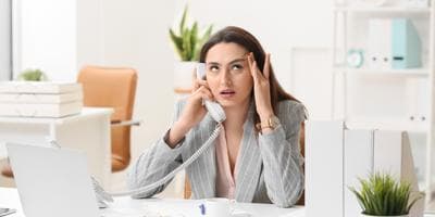 businesswoman talking on phone annoyed
