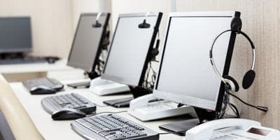 computers and headsets in empty office