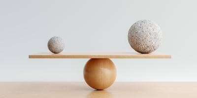Unequal-sized spheres in balance