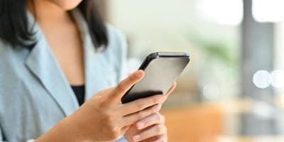 A closeup of a businesswoman looking at her phone