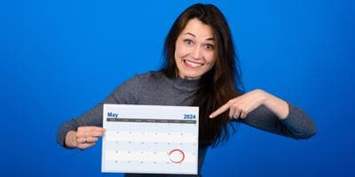 woman pointing at a calendar with May 24 circled