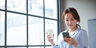 woman in breakroom looking at phone