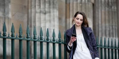 British woman looking at her phone