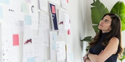 woman studying plans on a wall